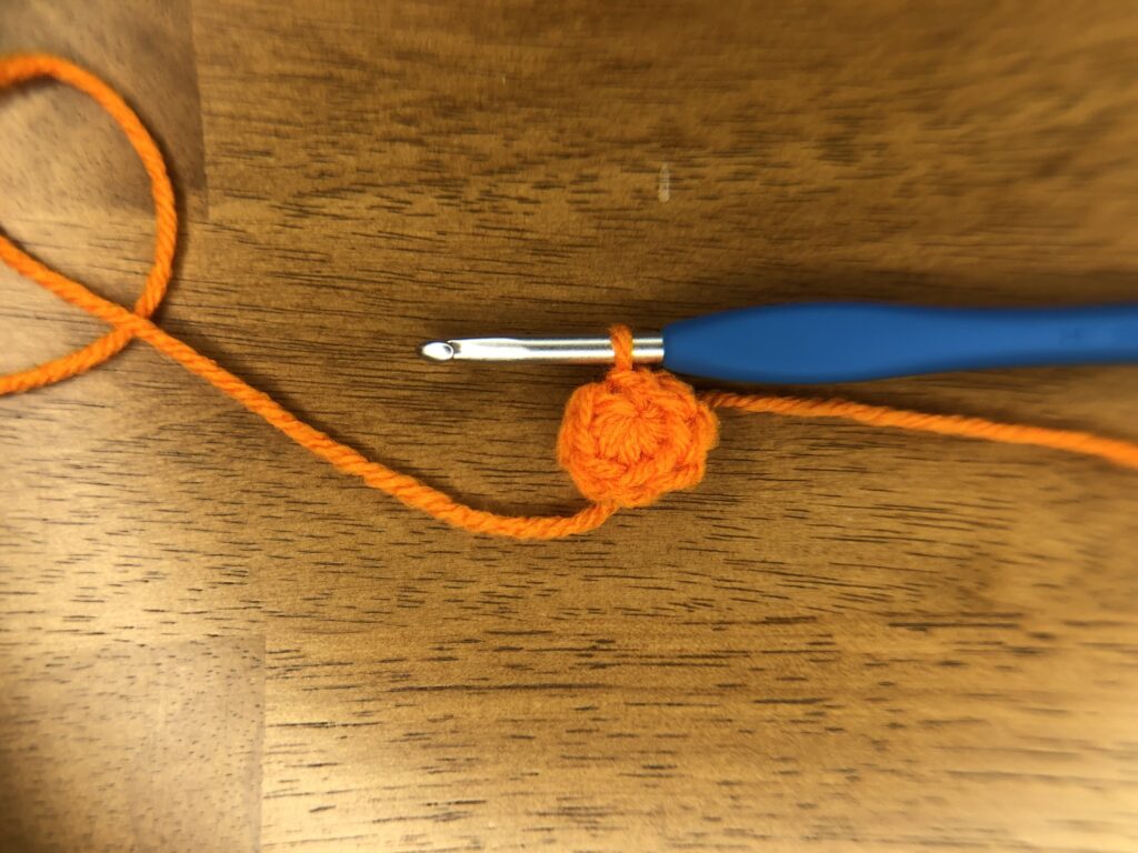 orange crochet magic circle with 8 sc stitches