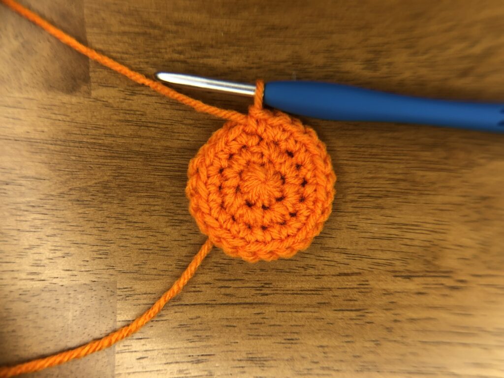 3 rounds of orange crochet in a circle for the beginning of a small jack-o-lantern pumpkin