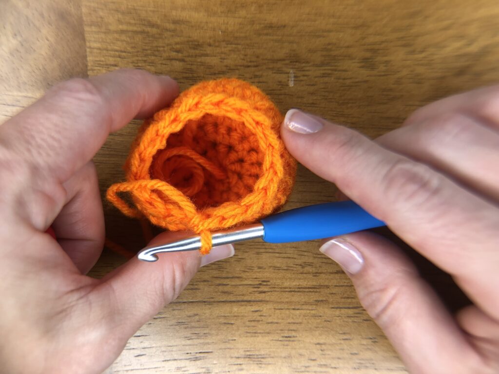 top of round of orange crochet ball to make baby pumpkins