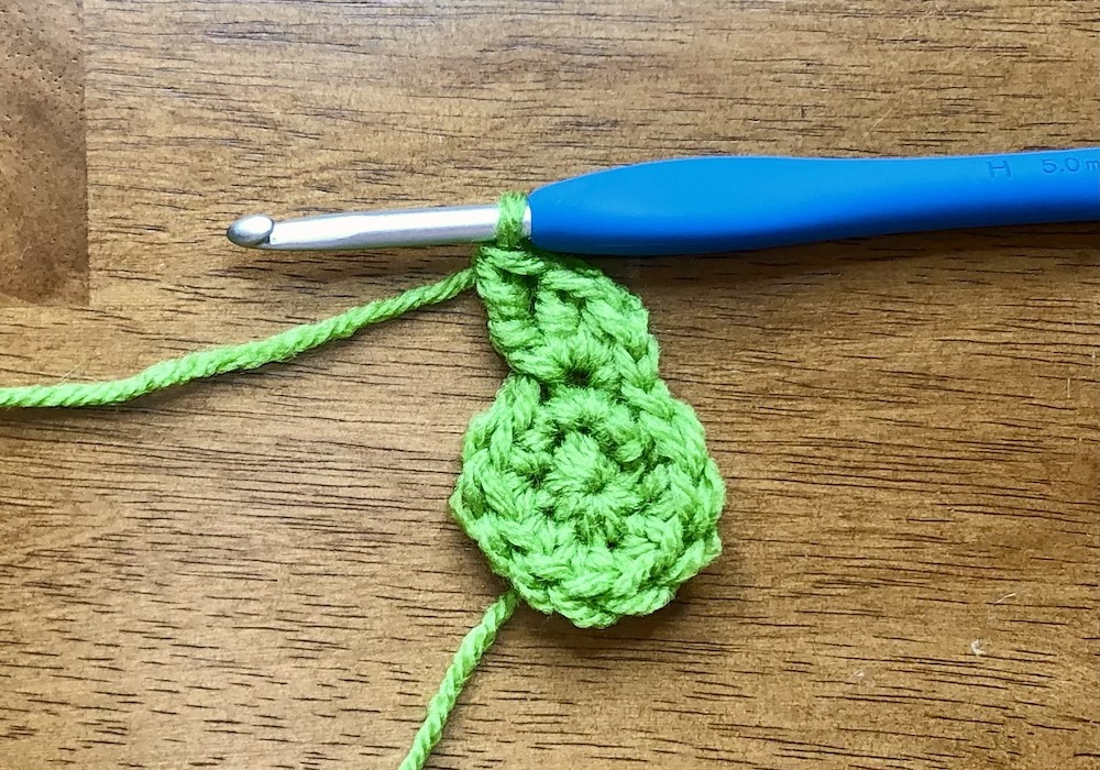 small green crocheted circle starting the 3rd round