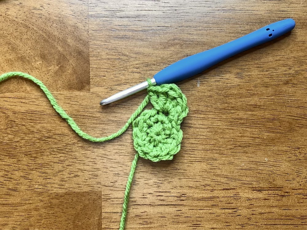 small green crocheted circle starting the 3rd round