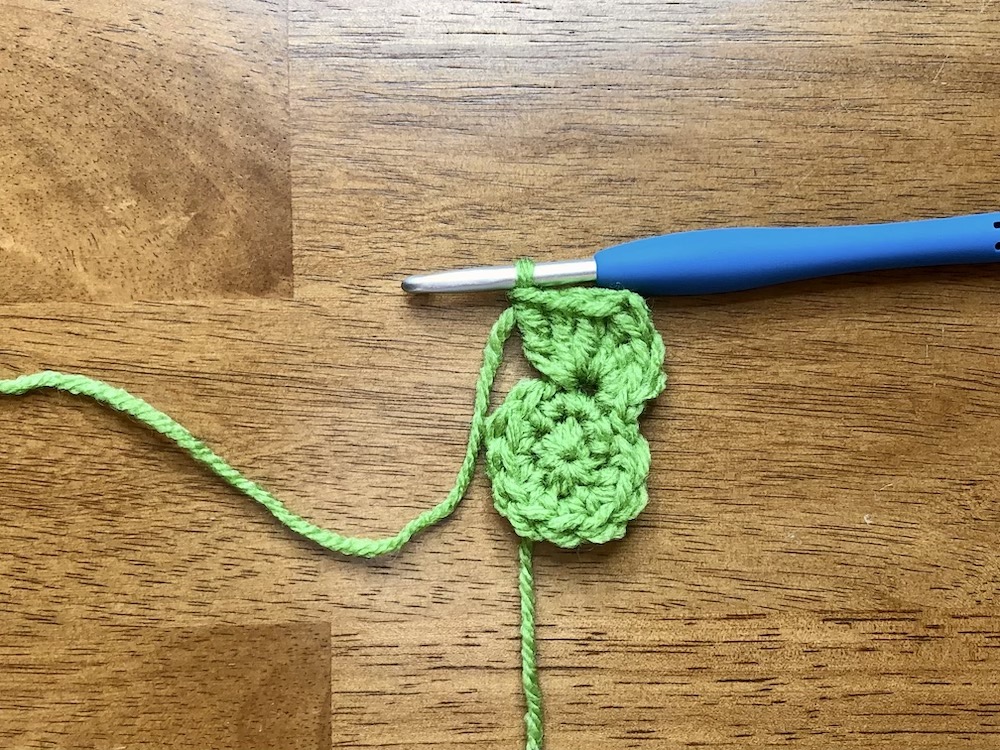 small green crocheted circle starting the 3rd round