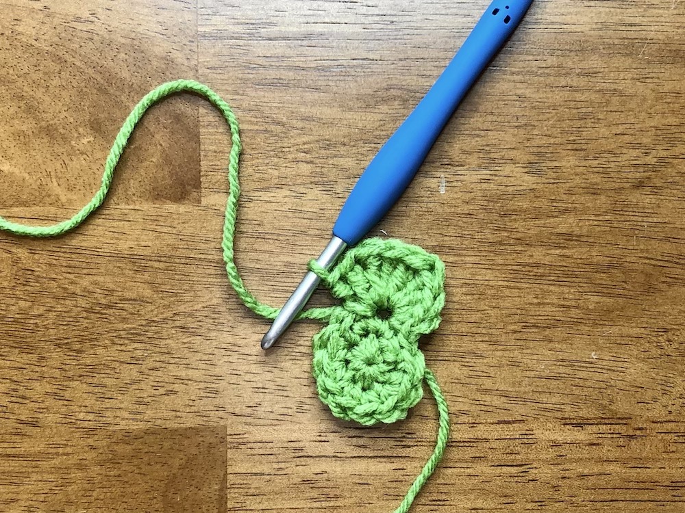 small green crocheted circle starting the 3rd round