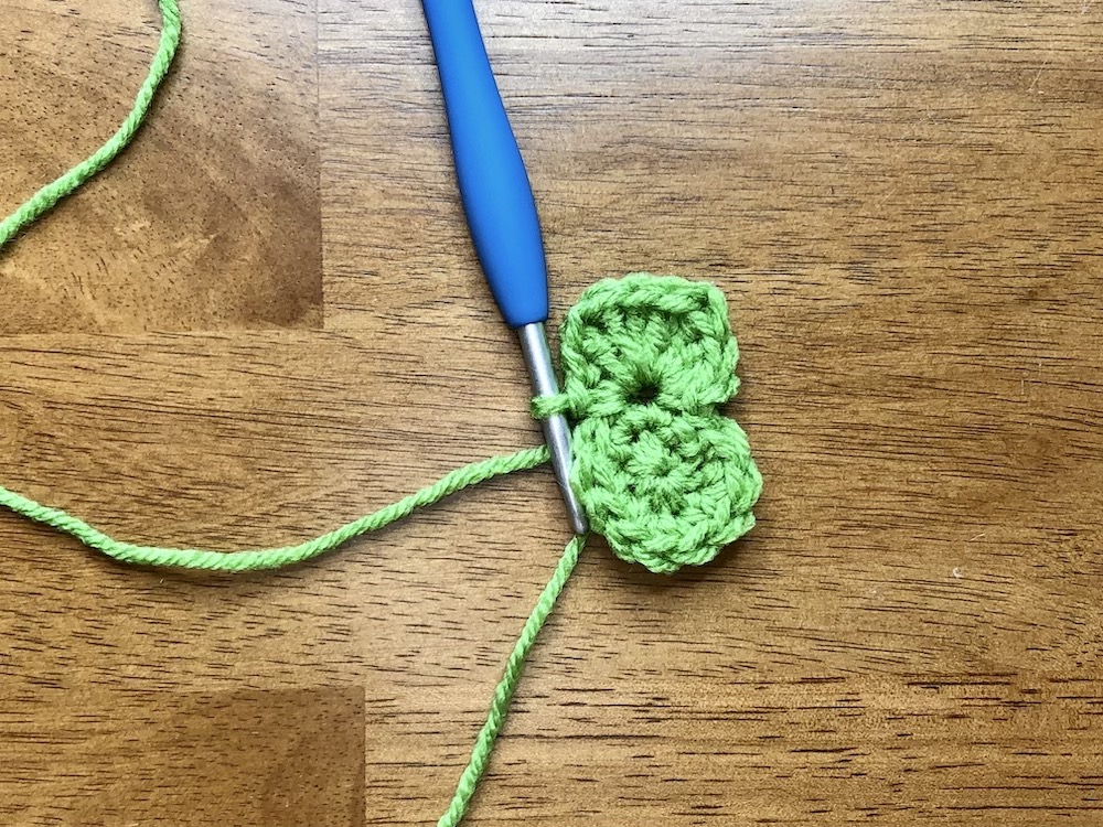 small green crocheted circle starting the 3rd round