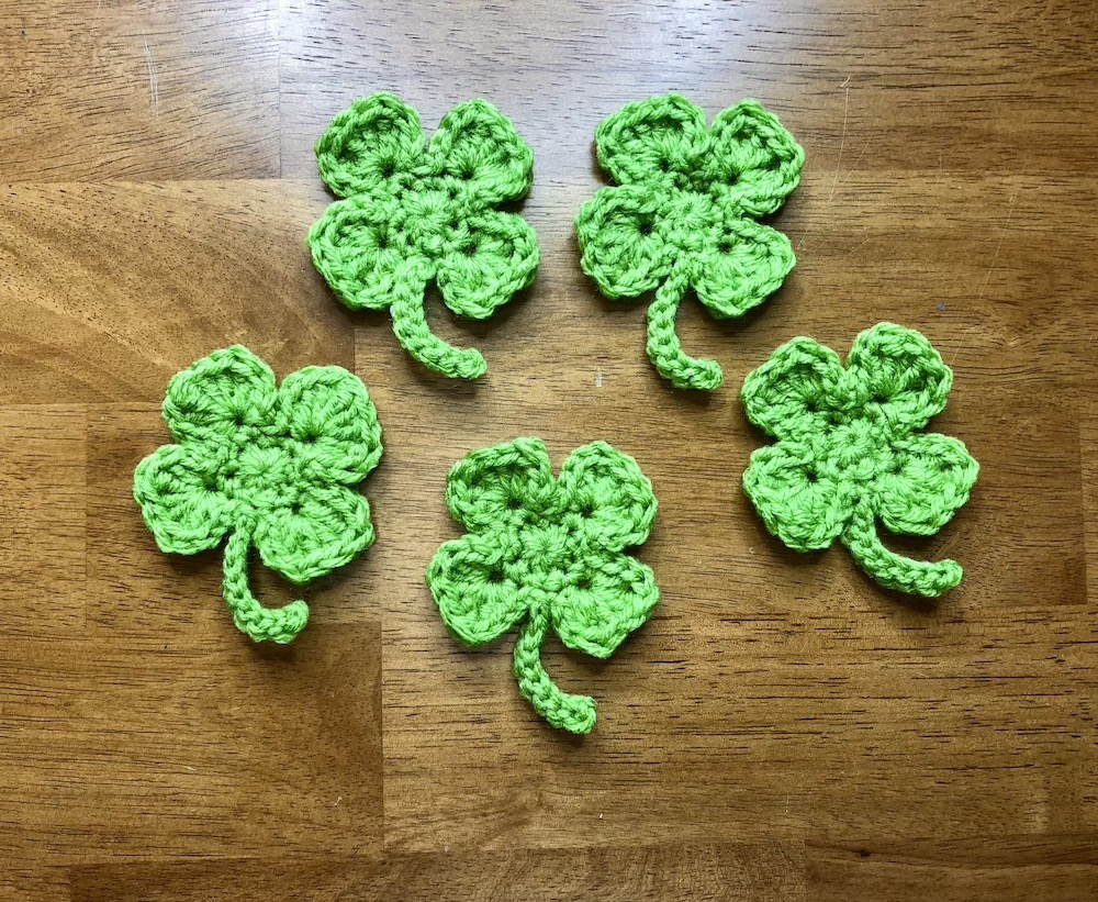 5 small green crocheted shamrocks
