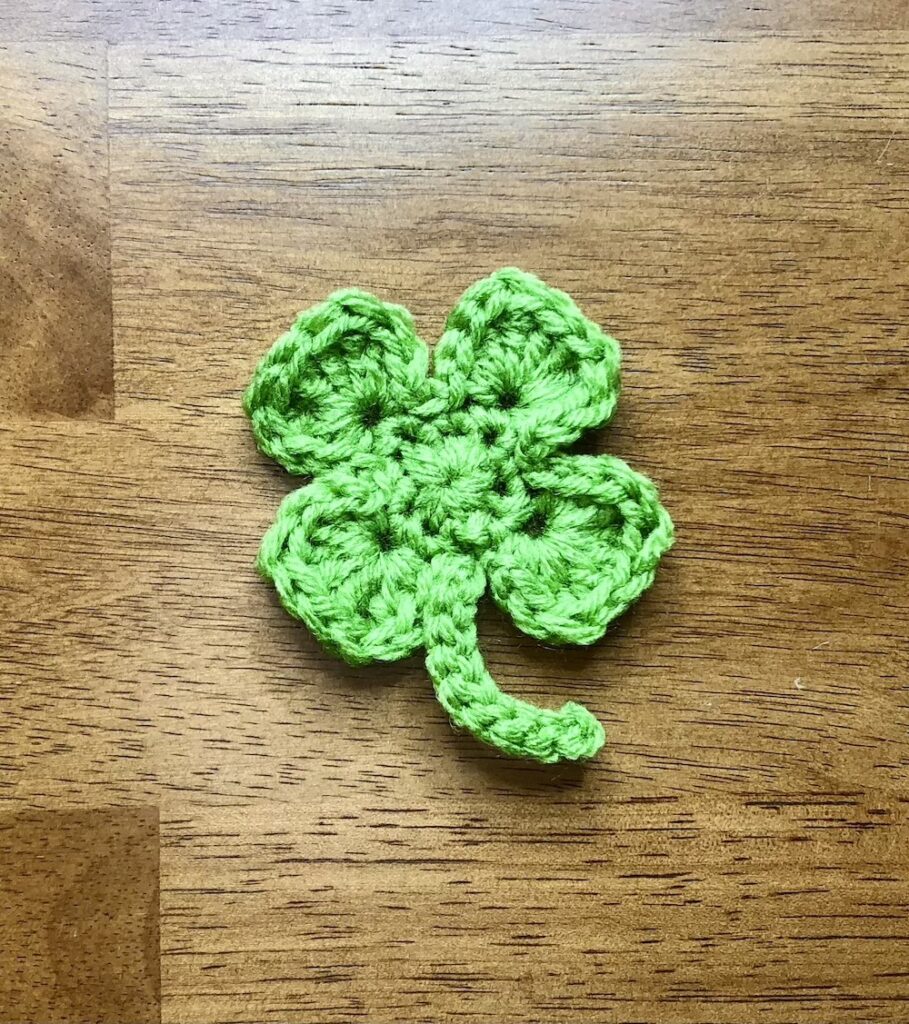 small green crochet shamrock approximately 2.5 inches across.