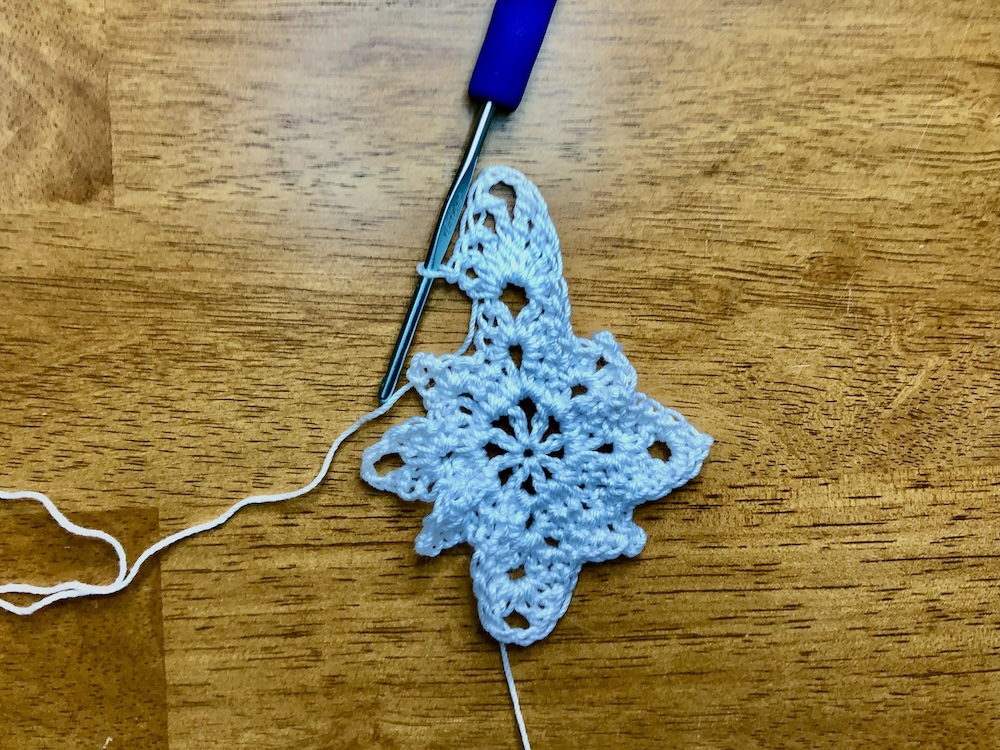 white christmas star ornament showing completed bottom point of the star