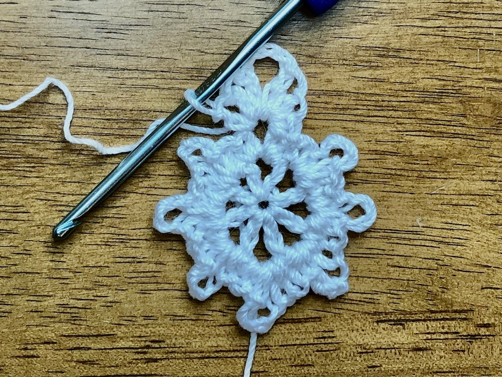 white crochet star showing the firs stitch combination for the third round