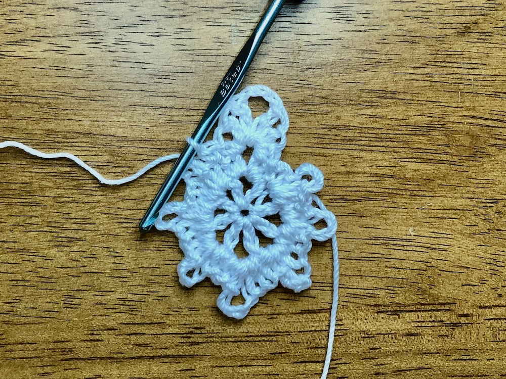 white crochet Christmas star showing location for single crochet in the 3rd round