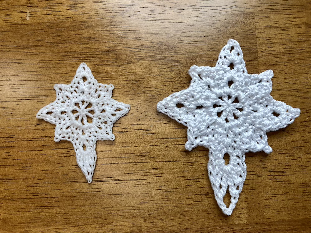 two crochet christmas star ornaments, small one made with number 10 thread on the left and larger made with number 3 thread on the right