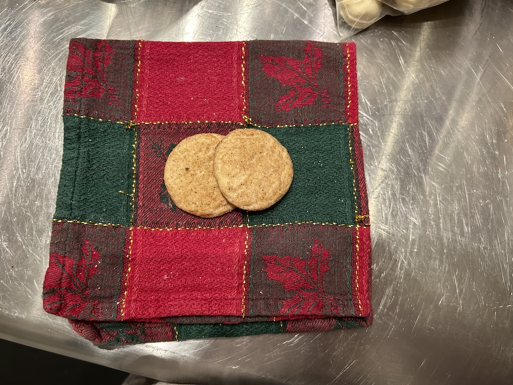 small round chai spiced snickerdoodle cookies on a red and green napkin