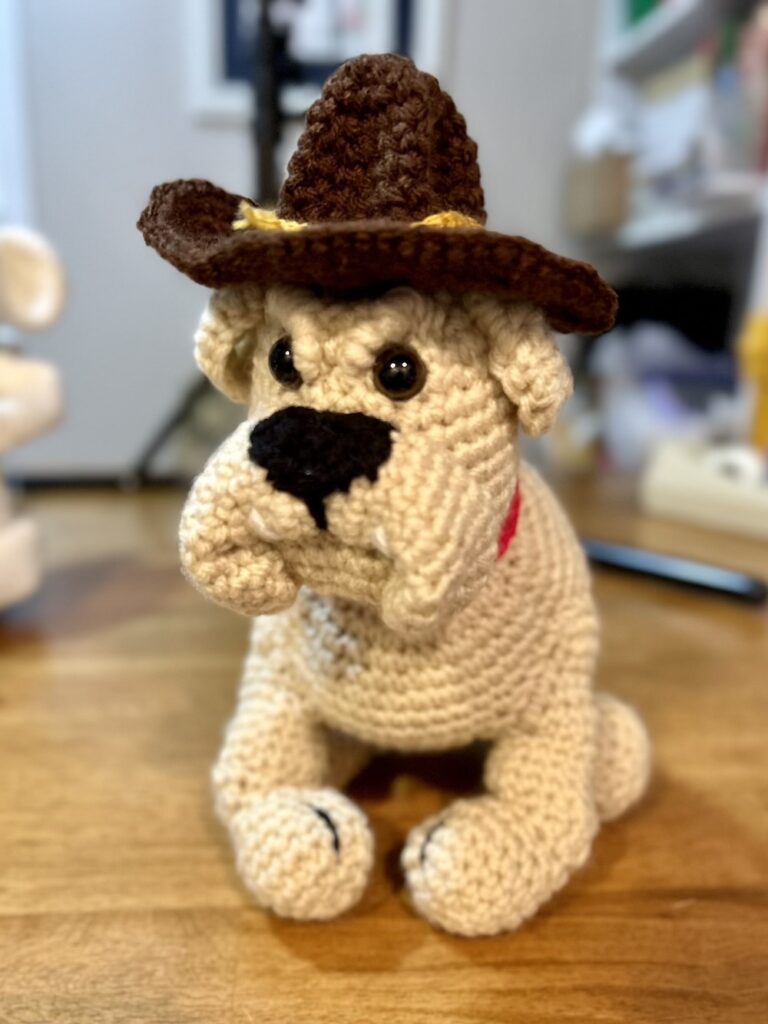 tan crocheted bull dog with Marine drill sergeant hat.
