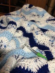 ripple pattern blanket in shades of blue and white