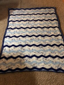 ripple pattern blanket in shades of blue and white